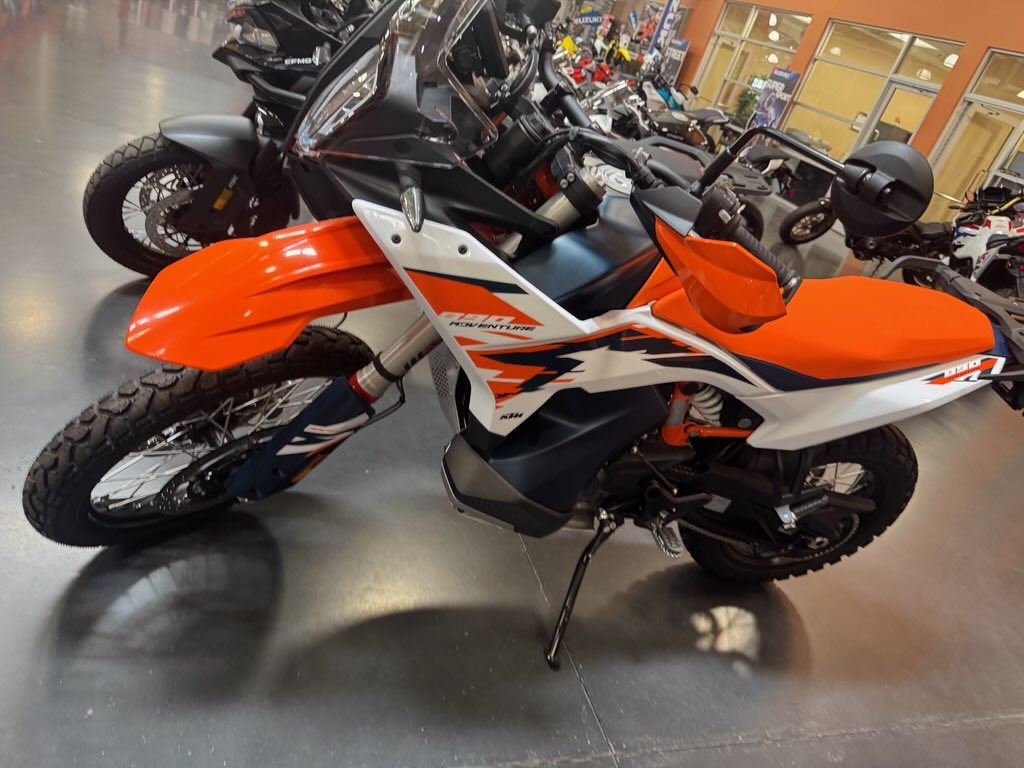 Cockpit of a KTM 890 Adventure R showing the handlebars, handguards and instrument display