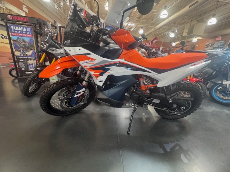 KTM 890 Adventure R in profile, orange and black rally bodywork on knobby tires